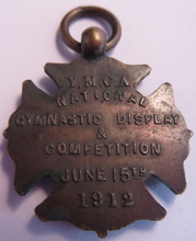 Load image into Gallery viewer, 1912 YMCA NATIONAL GYMNASTIC DISPLAY AND COMPETITION BRONZE MEDAL IN CLEAR FLIP
