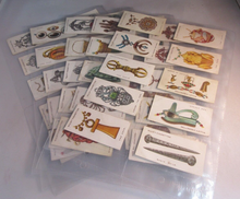 Load image into Gallery viewer, WILLS CIGARETTE CARDS LUCKY CHARMS COMPLETE SET OF 50 IN CLEAR PLASTIC PAGES
