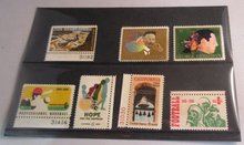 Load image into Gallery viewer, 1960&#39;S USA 7 X STAMPS MNH IN A CLEAR FRONTED STAMP HOLDER
