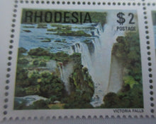 Load image into Gallery viewer, RHODESIA VICTORIA FALLS BLOCK OF 4 $2 STAMPS MNH IN CLEAR FRONTED STAMP HOLDER
